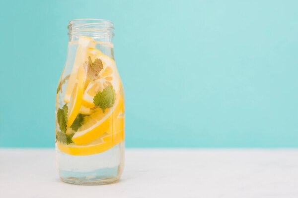 Clear glass bottle and water on a bright table
